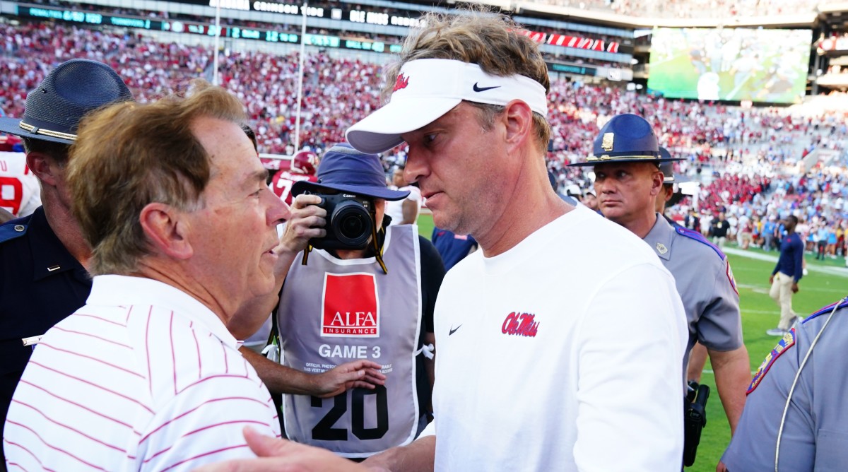 Alabama Crimson Tide head coach Nick Saban greets Mississippi Rebels head coach Lane Kiffin at midfield after a game.